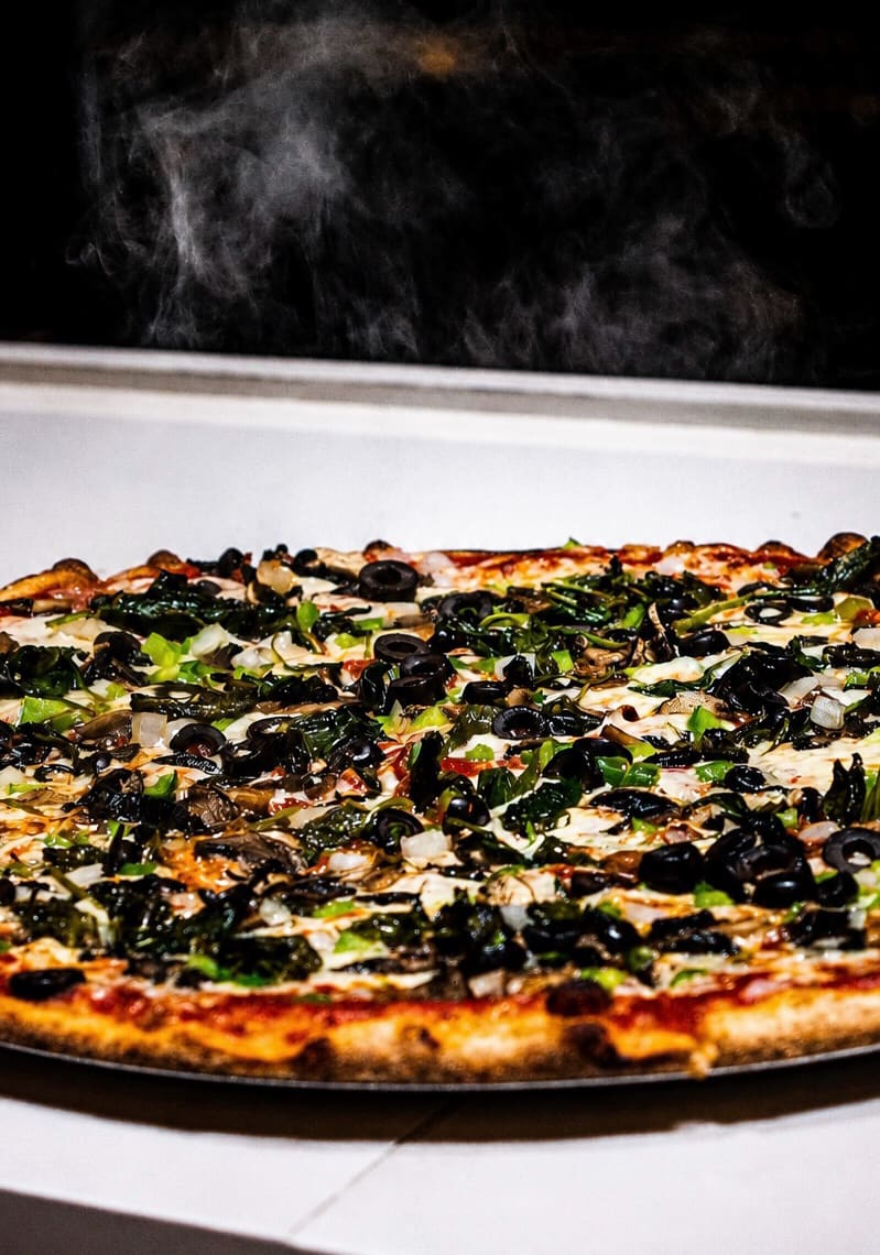 A fresh pie steaming on its tray